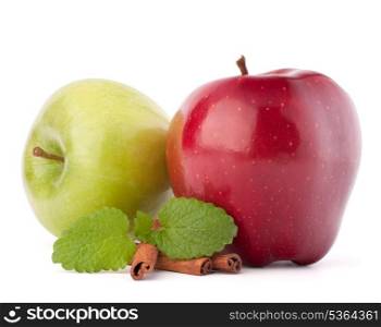 Red and green apples, cinnamon sticks and mint leaves still life isolated on white cutout