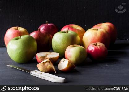 red and green apples on a black background