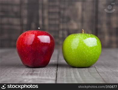 Red and green apples on wooden background