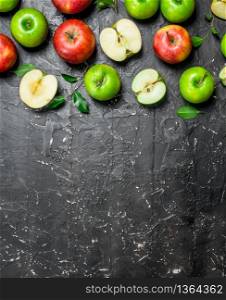 Red and green fresh apples. On a dark rustic background.. Red and green fresh apples.
