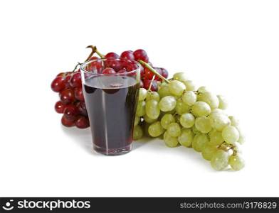 Red and green grapes with a glass of fruit juice