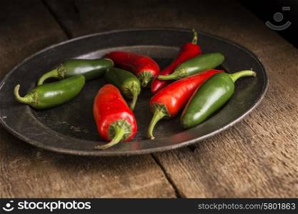 Red and green peppers in vintage moody natural lighting setting