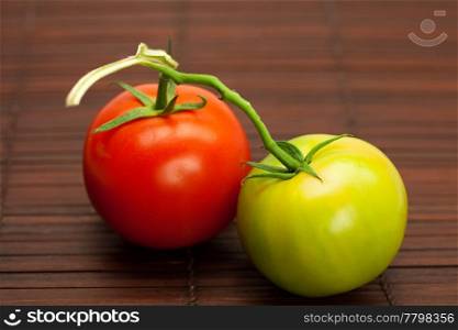red and green tomatoes on a bamboo mat