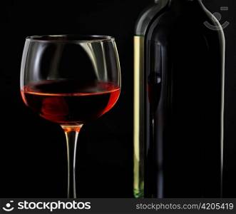 red and white bottles of wine on black background