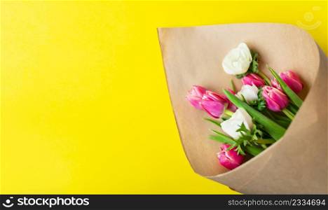 Red and white bouquet of tulips and anemones flowers on a yellow background. With copy space. Red and white bouquet of tulips and anemones flowers on a yellow background. With copy space.