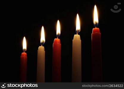 Red and white candles isolated on a black background