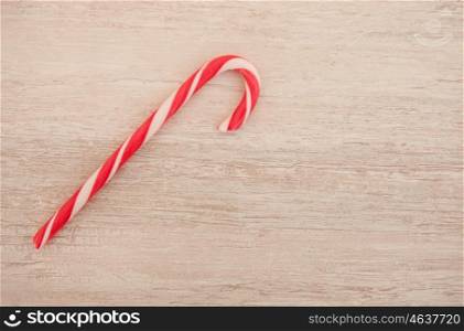 Red and white candy canes on a gray wooden background