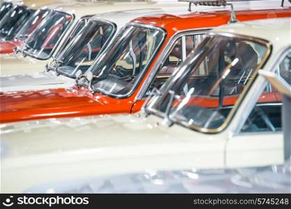 Red and white cars in a row on parking lot