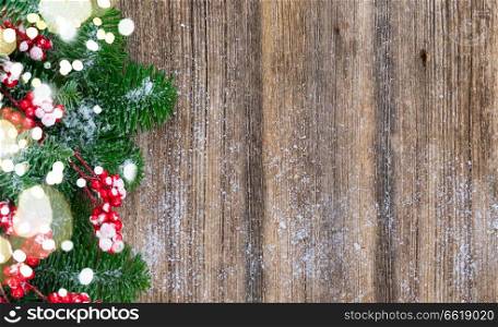 red and white christmas - twig with red berries and green evergreen tree on wooden background, banner with copy space. red and white christmas