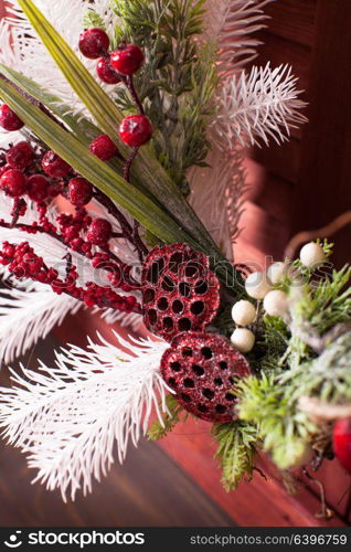 Red and white Christmas wreath. Christmas wreath on the wooden window. Red and white elements close up