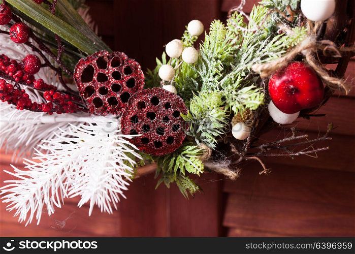Red and white Christmas wreath. Christmas wreath on the wooden window. Red and white elements close up