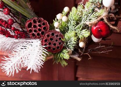Red and white Christmas wreath. Christmas wreath on the wooden window. Red and white elements close up
