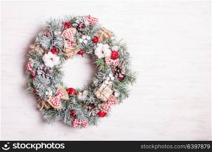 Red and white Christmas wreath with bows and cotton flowers. Red and white Christmas wreath