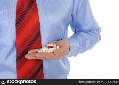 Red and white tablets in hand. Isolated on white background