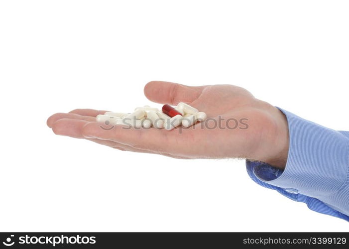 Red and white tablets in male hand. Isolated on white background