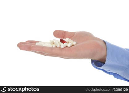 Red and white tablets in male hand. Isolated on white background