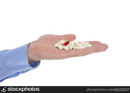 Red and white tablets in male hand. Isolated on white background