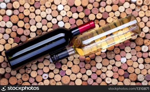 red and white wine bottles on the background of wine corks