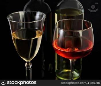 red and white wine glasses and bottles