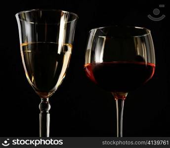 red and white wine glasses on black background