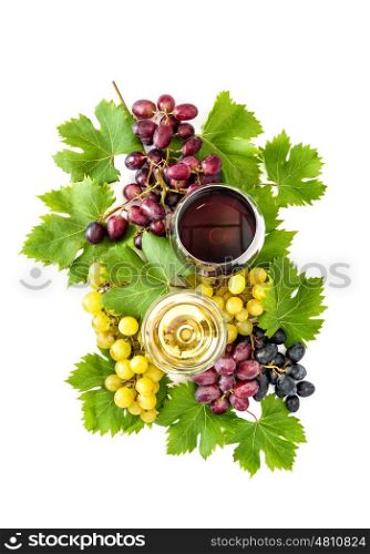 Red and white wine glasses with grape vine and green leaves