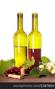 Red and white wine in bottles on the wooden table
