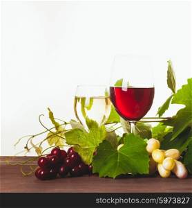 Red and white wine in glass over wooden table. Wine in glass