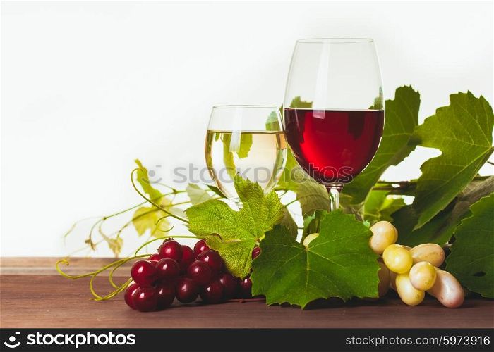 Red and white wine in glass over wooden table. Wine in glass