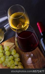 Red and wite wine in glasses with grape. Glass of red and white wine