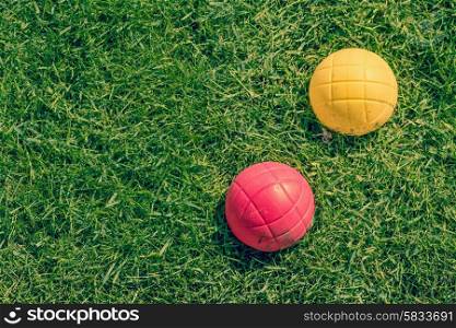 Red and yellow ball of a boccia garden game on the lawn