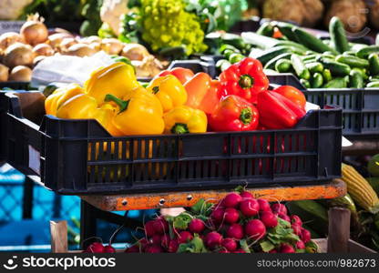 red and yellow bell peppers on a street market