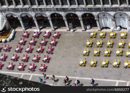 Red and Yellow Chairs and Round Tables Aerial View on Famous Saint Mark&rsquo;s Square in Venice, Italy