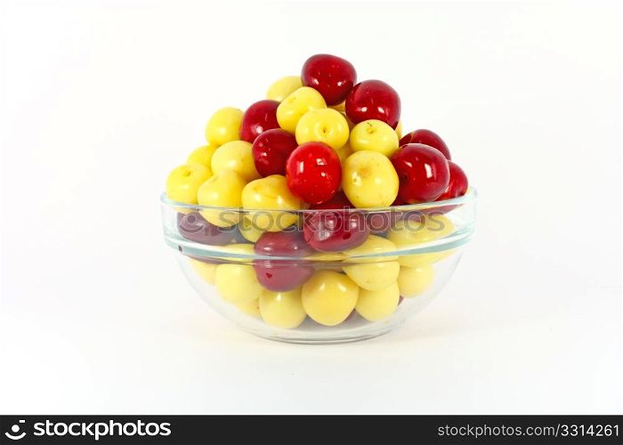 Red and yellow cherries isolated on white