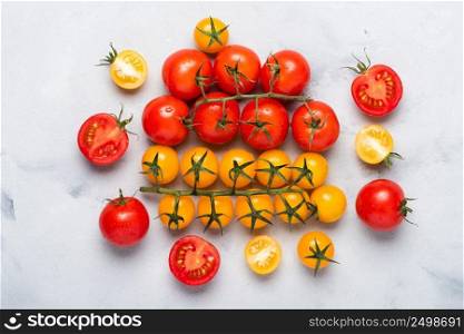 Red and yellow ripe cherry tomatoes on table top view