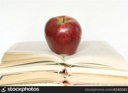 Red apple and stack of books for school