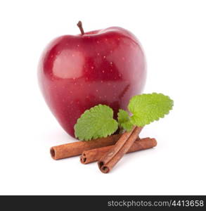 Red apple, cinnamon sticks and mint leaves still life isolated on white cutout.