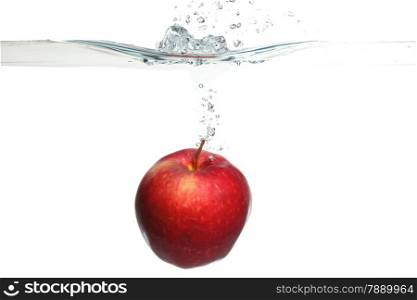 Red apple in the water splash over white background. Healthy food and active life.