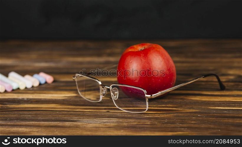 red apple near glasses