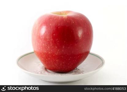 Red apple on a saucer