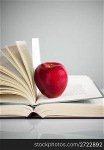 red apple on books