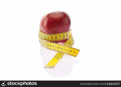 Red apple wrapped with measuring tape
