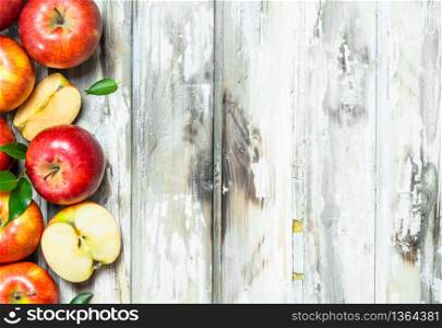 Red apples and Apple slices. On a white wooden background.. Red apples and Apple slices.