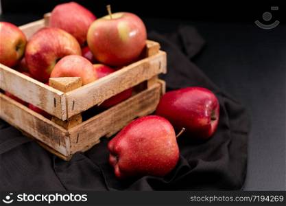 red apples in crate on black background