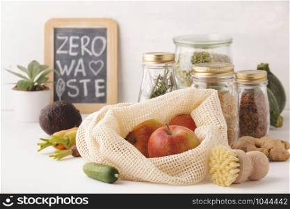 Red apples in reusable cotton bags and glass jars with pasta, lentils, beans, rice, dry herbs. Zero waste, Recycling, Sustainable lifestyle concept
