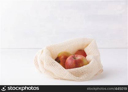 Red apples in reusable cotton bags. Zero waste, Recycling, Sustainable lifestyle concept. Red apples in reusable cotton bags. Copyspace