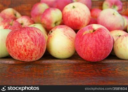 Red apples laying on wooden bench