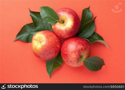 Red apples with leaves over paper background. Gala apple composition. Top view