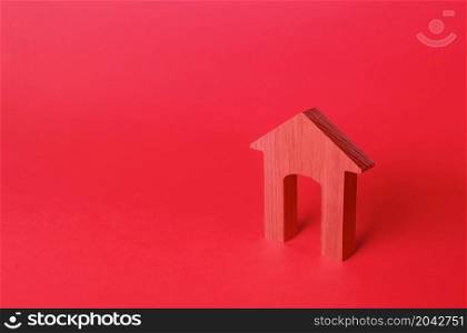 Red arch house figurine. Affordable housing. Rent of real estate. Repair and renovation, modernization. Minimalism. Red login background. Concept entrance. Realtor services.