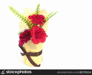 Red artificial bouquet flower and green leaves with brown ribbon isolated over white