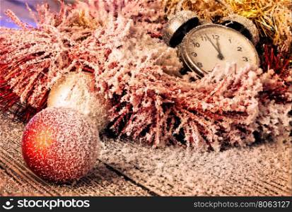 Red ball and clock in Christmas decoration covered with snow. Red ball and clock in Christmas decoration